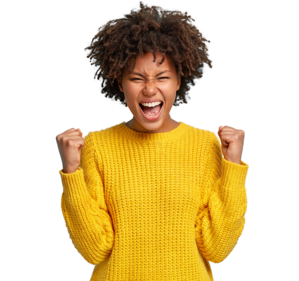 A woman wearing a yellow sweater holds her fists in excitement